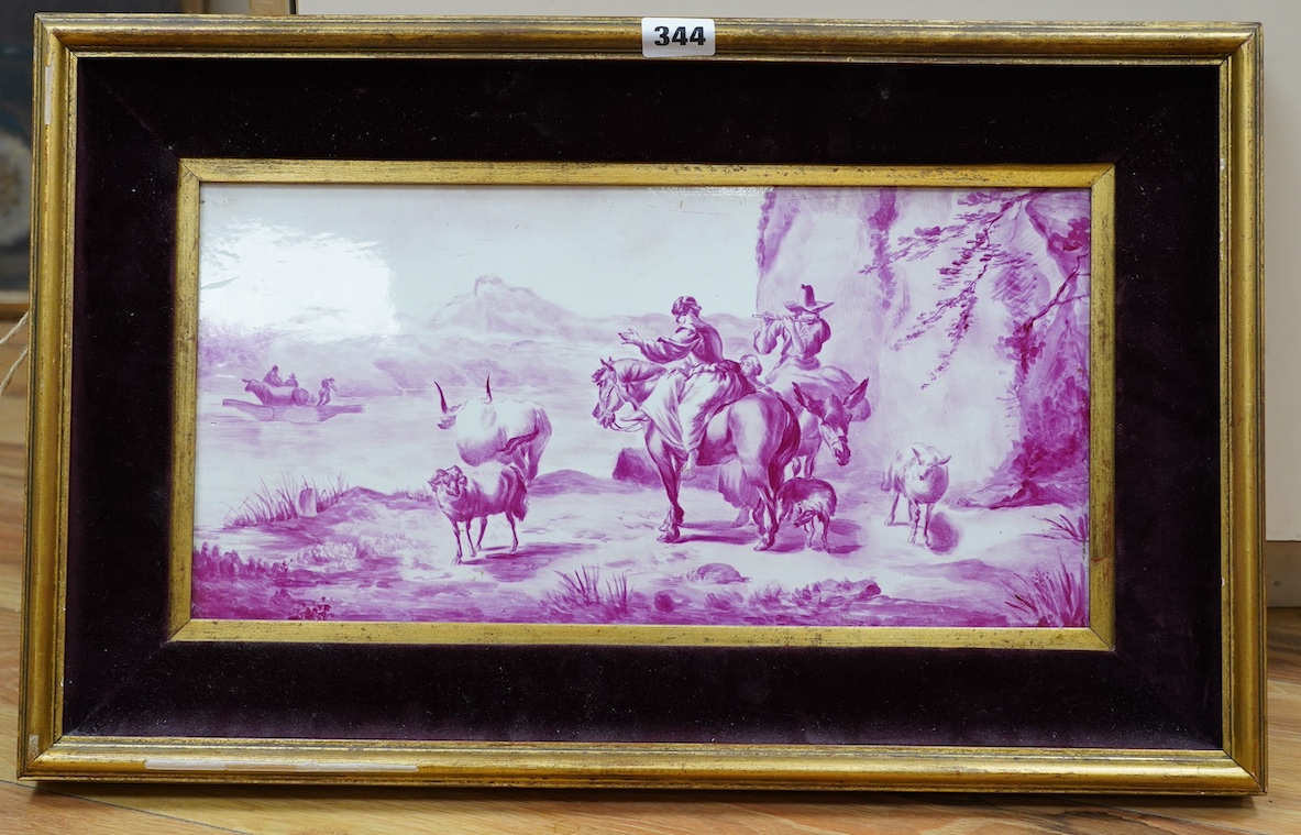 A framed Continental puce camaieu painted pottery plaque. 39cm wide, 19cm high. Condition - plaque good, frame chipped